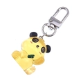 Close-up of a yellow translucent resin panda keychain with silver metal hook detail - Yellow