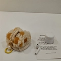 Detail view of a cute colorful waffle fleece earphone pouch with pearl keychain - Yellow Plaid