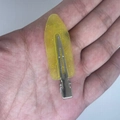 Sparkly yellow sequin leaf hair clip with metal base shown on hand for size - Transparent Yellow with Gold Glitter