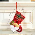 Red burlap Christmas stocking featuring 3D Santa Claus and green plaid cuff details - Mini Linen Santa Style