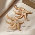 Macro view showing gold starfish earrings with white rhinestones and size dimensions - Eco-friendly KC Gold Starfish Style (WEH4922)