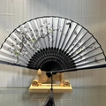 Chinese folding fan with plum blossoms, black striped silk, and decorative tassel - Spring Garden (Light Grey)