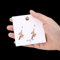 Handheld Christmas candy cane earrings with golden bow and crystals on black background - Mini Candy Cane