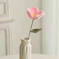 Handmade pink crochet tulip flower in a white vase with green leaves and soft lighting - Blooming Tulip (Single) / Pink