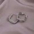 Silver multi-layered geometric square hoop earrings on a soft silk textured background - E-065---Platinum