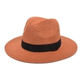 Detail of woven straw fedora hat in reddish brown with a classic black ribbon band - Caramel color