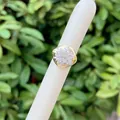 Detailed macro shot of 18K gold plated ring with cluster set white zircon stones - Round Flower Cluster