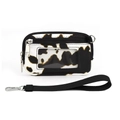 Detail of cow print card holder featuring transparent window and black wrist strap - Black White Brown Cow