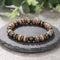 Detailed view of 8mm wooden spacer bracelet with black mantra beads on a stone plate - ZJ11745-Six-Character Mantra Black and Wood Bead Bracelet