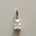 Macro detail of white resin gummy bear pendant with gold-plated rhinestone bail link - White