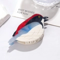 Detailed view of parrot bird shaped acetate hair claw clip on minimalist background - Blue Finch
