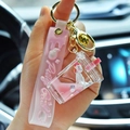 Pink liquid quicksand unicorn milk tea cup keychain with glitter and Pretty Girl wrist strap - Sakura Pink