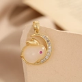 Macro view of a gold-plated crescent moon and rabbit pendant with sparkling crystals - Gold Crescent Moon Rabbit