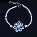 Detail of silver-tone tennis bracelet with blue zircon flower charm and S-clasp - Bracelet (16+3cm)
