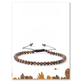 Detailed view of handmade tiger eye beaded bracelet with adjustable black cord on display card - Tiger Eye Bracelet