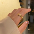 Detailed view of an 18k gold plated titanium steel braided open ring worn on a hand - KTG037J-3D Intertwined Twist Style