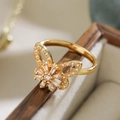 Macro shot of 18K gold plated butterfly ring with sparkling cubic zirconia on wood - Butterfly (14531)