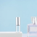 Clear glass roller bottle for perfume with elegant silver metal cap on white podium - 3ml Silver
