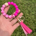Detail of pink silicone beads, wood bead, and leather tassel on a key ring bracelet - A-009/Rose Red Marble + Pink Tassel