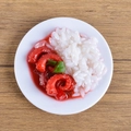 Realistic PVC miniature bowl of roast pork with green peppers on a wooden table - Squid Rice Bowl