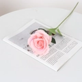 Pink velvet artificial rose stem with green leaves on an open magazine display - Large Round Bean Paste