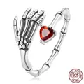 Gothic 925 sterling silver skeleton hand open ring featuring a red heart shaped gemstone - Skeleton Hand Heart Open Ring (SCR876)