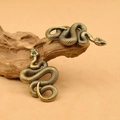 Detail view of retro brass snake figurines showing detailed scale texture on aged metal surface - Snake