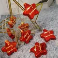 Red star-shaped LED Christmas lights with gold Merry Christmas print on a wire frame - 1.5m 10 LEDs Steady Battery Red Stars