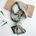 Elegant dark green and beige silk scarf featuring vintage letter patterns tied in a knot - D-Pattern Framed Green