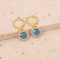 Detailed close-up of golden hoop earrings with blue heart-shaped cubic zirconia charms - Lake Blue Earrings