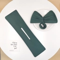 Detail of dark green fabric hair bun maker set with bow tie and textured cloth - Dark Green