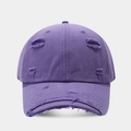Detailed close-up of distressed ripped details on purple vintage cotton baseball cap - Purple