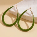 Detailed view of green resin teardrop earrings on white marble, minimalist gold metal hooks - Hoop Earrings-Green-Water Drop