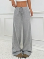 Detail of grey knitted wide-leg drawstring pants with vertical texture on model - S / Bottoms / Light Gray