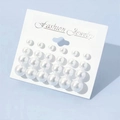 Detailed view of 12 pairs of minimalist pearl stud earrings on white jewelry card - 12 Pairs Set / White