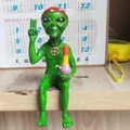 Green alien resin figurine wearing a red headband and peace necklace holding a water pipe - Alien with Red Hat
