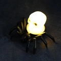 Halloween spider LED candle with a glowing yellow skull light for spooky decor - Spider Skull
