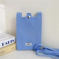 Detail of light blue knit phone bag featuring a metal snap closure and brand label - Sky Blue