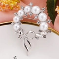 Silver wreath brooch with white faux pearls and crystal bow detail on elegant plate - Silver Bow Wreath Pearl Brooch (4072970)