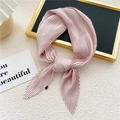 Pink pleated square silk scarf for women displayed on beige textured background - Pink