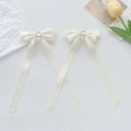 Barrettes noeuds en satin crème avec cristal de cœur violet en lot de deux - Beige