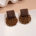 Detailed view of geometric wooden bead hoop earrings on a white ceramic plate - Coffee (925 Sterling Silver Earring Post)