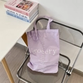 Detailed shot of purple canvas tote bag with floral print on a modern clear chair - Purple