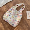 Detaillierte Draufsicht der großen Mesh-Einkaufstasche mit bunten Blumenmustern - Westentaschen-Stil / Buntes Blumenmuster