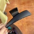 Close-up of a large matte black butterfly hair claw clip held by hand in home setting - XL Butterfly Buckle (Approx. 13.5cm) / Matte Black