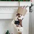 Close-up of cow print plush Christmas stocking hanging on a rustic white fireplace - 20 inch / Burlap Trim Cow Print