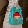 Bolso tote azul con bordado de mono y correa de hombro tejida de colores vivos - Mono de Boca Grande Verde