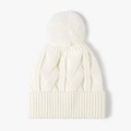 Winter cable knit beanie in cream white featuring a soft faux fur pom-pom on top - Cream