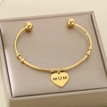 Close-up of golden stainless steel heart MOM charm bracelet in a luxury jewelry box - MOM Hollow Heart Round Beads Style (KB152717-Z)