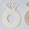 Macro detail of laser-cut diamond ring paper place cards in cream and light brown - Ivory